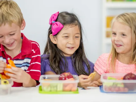 Children eating a healthy school lunch.