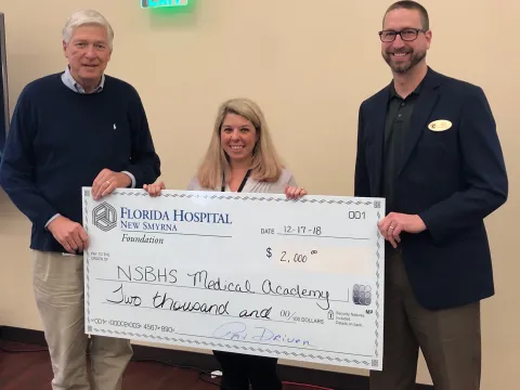 Pictured from left to right: Pat Driver, AdventHealth New Smyrna Beach Foundation chair, Lindsay Posick, New Smyrna Beach High School Medical Academy, and Julian Doster, New Smyrna Beach High School assistant principal.