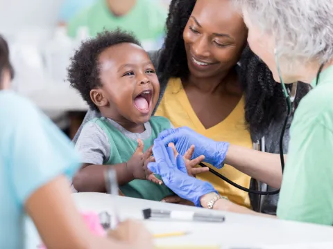 Nurse Taking Care of a Happy Baby