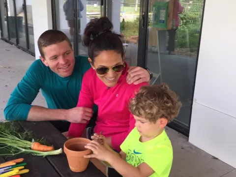 A family sitting outside at a table.