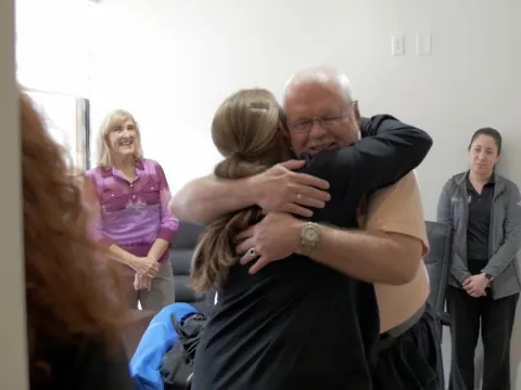 Robert hugs one of the nurses who cared for him during treatment.
