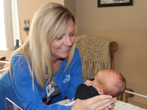 AdventHealth employee holding a baby
