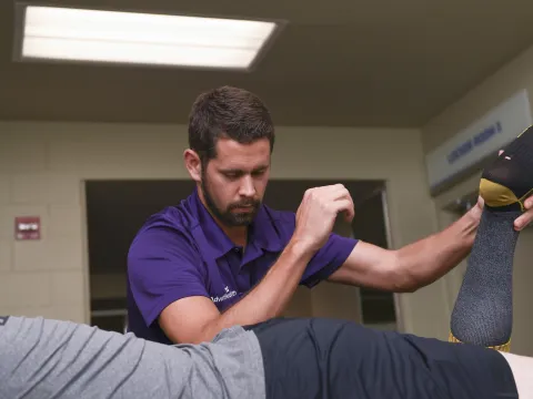 AdventHealth Physical Therapist working on a Solar Bears team member.