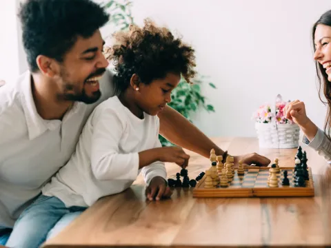 A family keeps their brains active by playing chess.