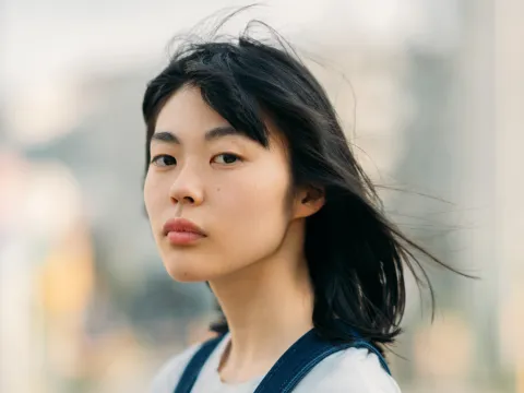 A Woman Looks Both Ways Before Crossing the Street
