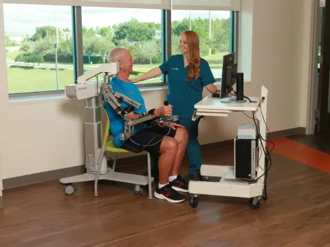 A patient and a nurse doing a rehabilitation session