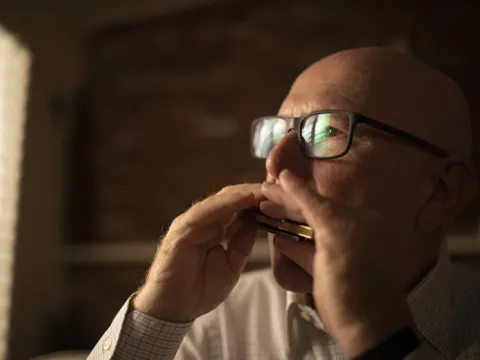 Man playing a harmonica