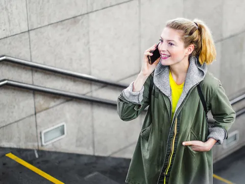 A woman walking up stairs while talking on the phone