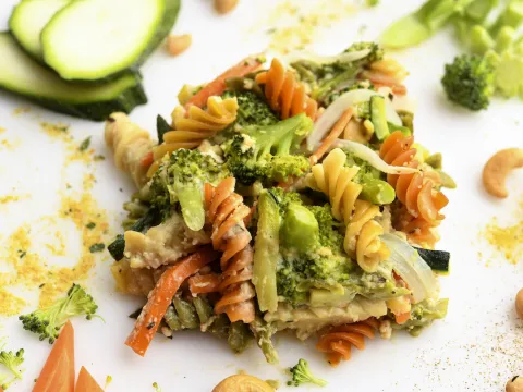 Square of veggie-pasta casserole with zucchini garnish