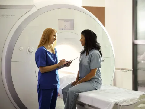 Woman Patient Getting MRI Talking to Nurse