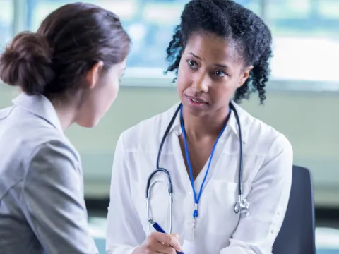 Woman talking to her doctor about getting a mammogram