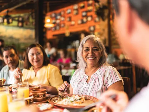 A group of adults having dinner at a restaurant.