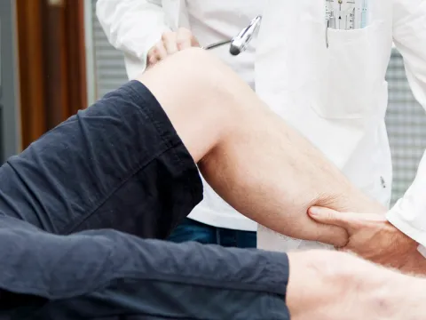 Doctor examining patient's knee
