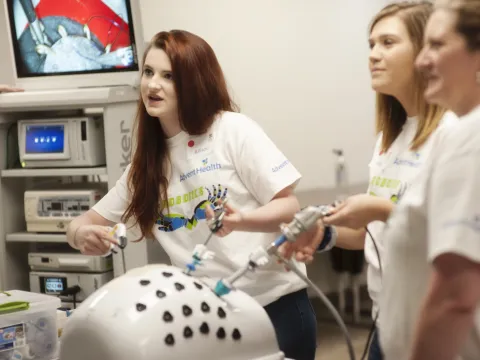A group of people learning about Robotic Surgery.