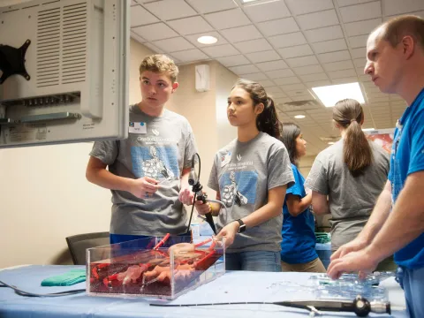 Students trying a surgical demo at the AdventHealth Gordon Robotic Surgical Outreach Program 2018.