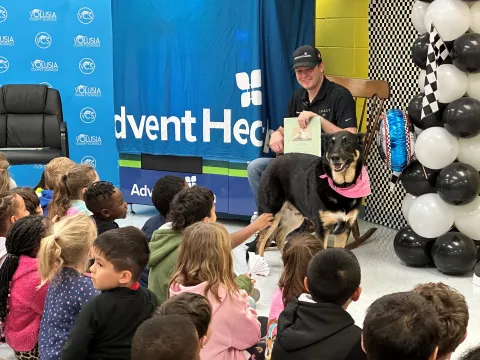 NASCAR Driver Reads to Children and Delivers a "Bookworm" Vending Machine to Local Elementary School