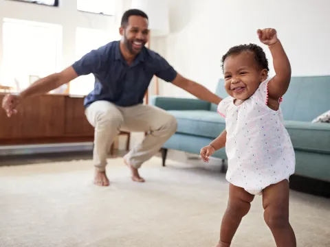 A father and baby playing at home.