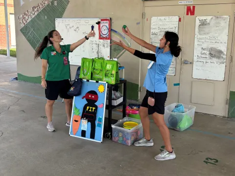 Two women perform a demonstration for the Mission Fit program.