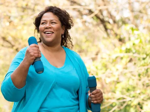 An overweight woman exercising outdoors