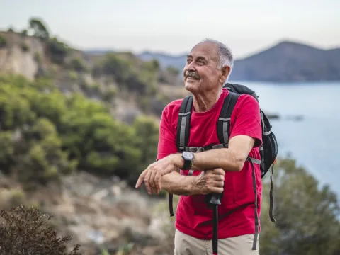 Older male hiker taking a break from his walk