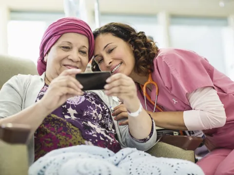 A young nurse and her female cancer patient taking a sweet selfie.