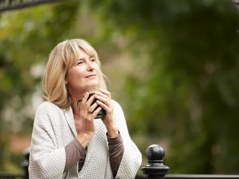 woman holding cup outdoors