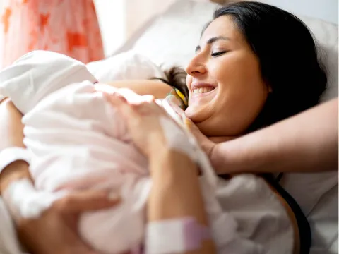Mom giving birth in the hospital.