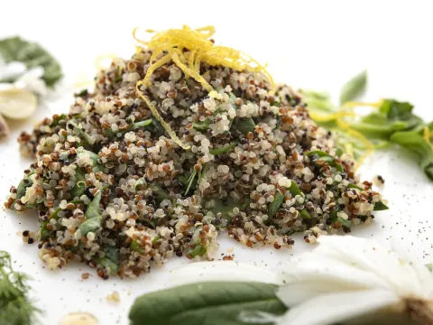 Mound of quinoa salad with green garnishes