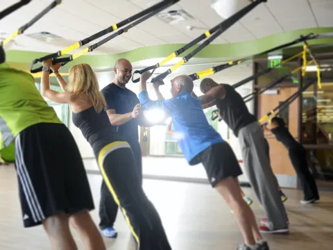 Indoor group exercise class and instructor using 