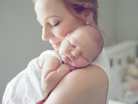 A new mom holds her infant.
