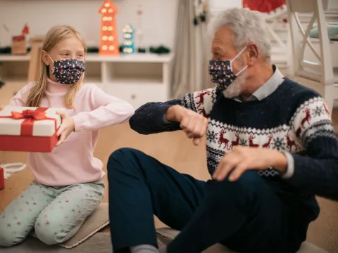Grandpa giving presents to granddaughter