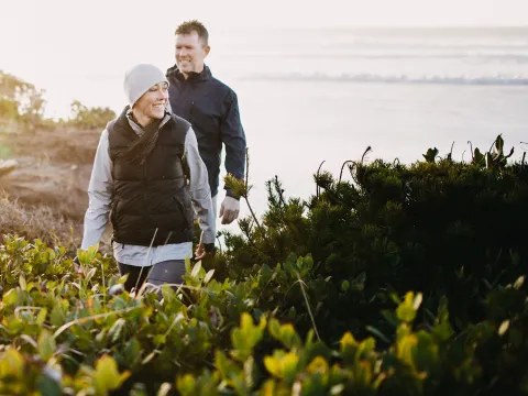 A couple hiking in a bushy area