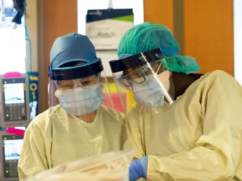 Nurses perform some testing in full personal protective equipment