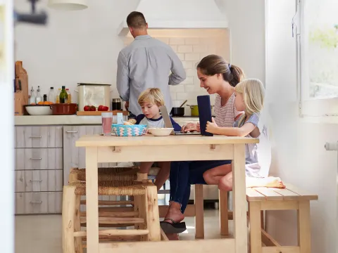 A young family sits around the table for breakfast