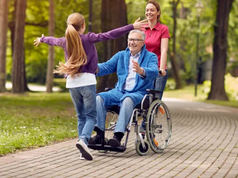 A multi-generational family enjoys time together in a park.