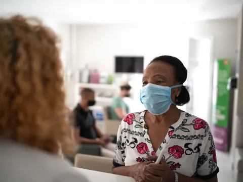 An elderly woman talking with her doctor