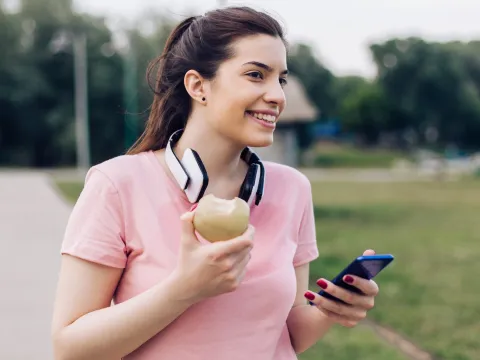 A woman eating an apple.