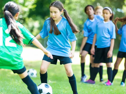 A group of girls playing soccer.
