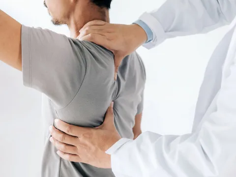 A man having his spine examined.