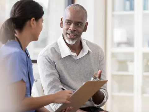 A man discussing his care with his doctor.