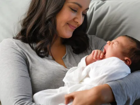 A mom holds her newborn infant.