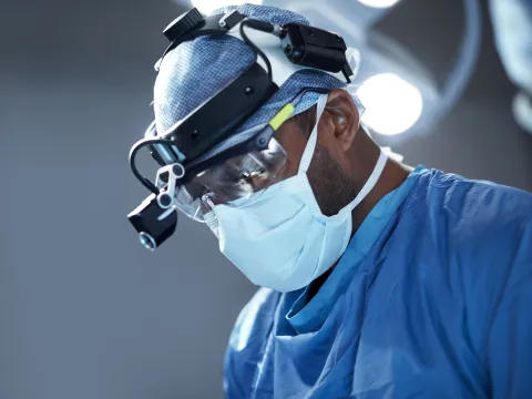 A doctor focused while doing his surgery