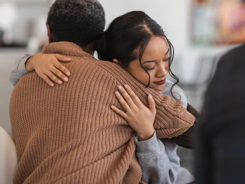 Two women hugging each other.