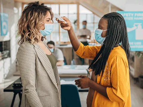 A woman getting her temperature checked