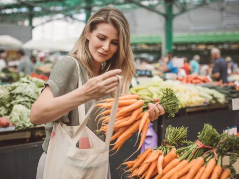 A woman shops for produce at the grocery store