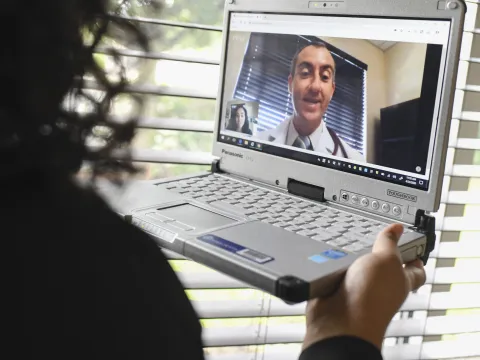 A woman has a video visit with her AdventHealth doctor.