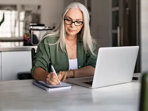 Woman with planner and laptop.