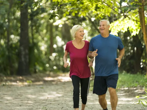 Older couple Jogging through the woods