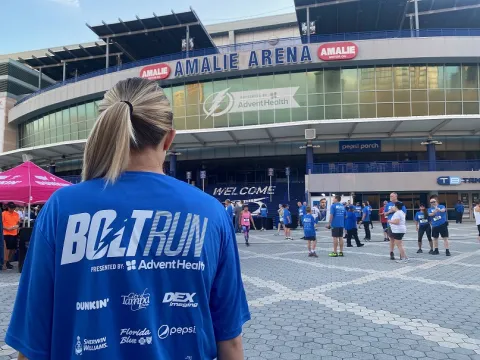 Bolt Run runner stands in front of Amalie Arena