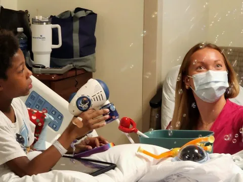 King, a nine-year-old pediatric patient at AdventHealth Tampa, explores toys purchased through The Toy Foundation Play Grants Program.